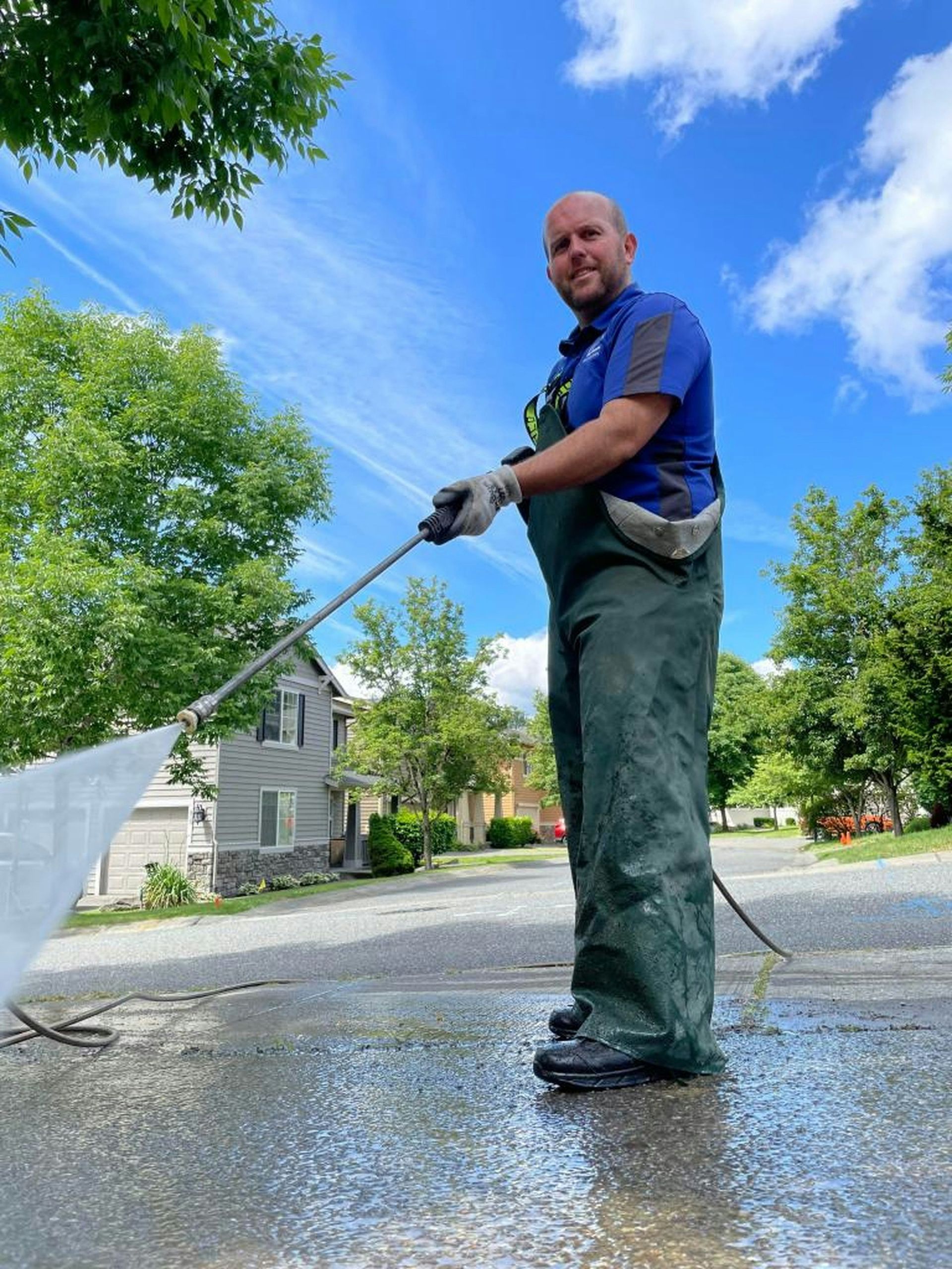 a man is cleaning the street with a hose